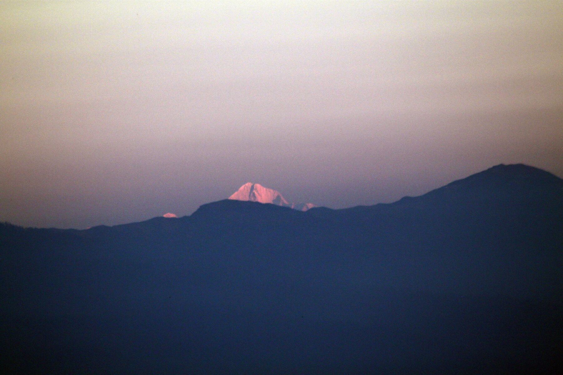 Mount Everest lit orange-pink at dawn